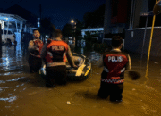 Personel Polres Tangsel Sigap Evakuasi Warga di Tengah Banjir