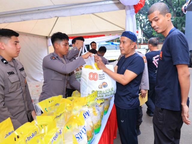 Anggota Divhumas Polri salurkan paket Gerakan Pangan Murah 2025 kepada warga di Lapangan Apel Divhumas Polri.