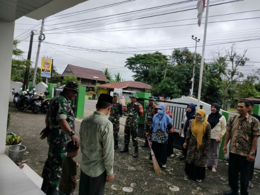Personel Koramil 07 Baranti bersama staf KUA Baranti melaksanakan karya bakti membersihkan lingkungan sekitar kantor, Sabtu (30/08/25).