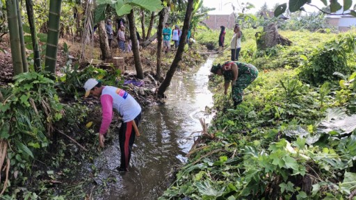 Anggota Koramil 07 Baranti bersama warga membersihkan selokan di Lingkungan Benteng, Sidrap, dalam kegiatan Karya Bakti untuk menjaga kebersihan lingkungan dan mencegah banjir.