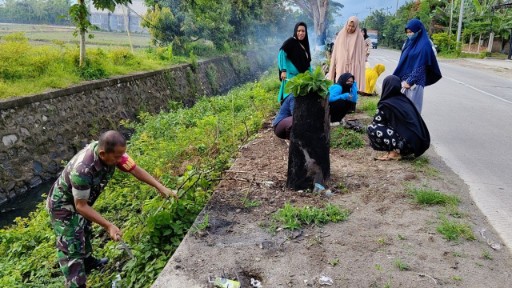 Babinsa Serma Nursalam memimpin pembersihan saluran air bersama warga Desa Kanie di Sidrap untuk mencegah banjir dan menjaga kebersihan lingkungan.